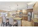 Spacious kitchen features granite countertops, stainless steel appliances, and a breakfast bar at 12748 N 57Th Dr, Glendale, AZ 85304
