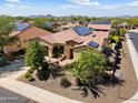 Aerial view of a home with solar panels, a tile roof, and desert landscaping at 12904 W Dale Ln, Peoria, AZ 85383