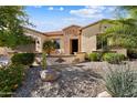 Beautiful house featuring desert landscaping, brick accents, and a welcoming front patio at 12904 W Dale Ln, Peoria, AZ 85383