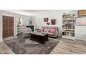 Cozy living room with a fireplace, stylish decor, and a large area rug over hardwood flooring at 1401 E Puget Ave # 4, Phoenix, AZ 85020