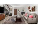 Inviting living area with hardwood floors, fireplace, comfortable seating, and staircase to the upper level at 1401 E Puget Ave # 4, Phoenix, AZ 85020