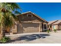 Beautiful single-story home with a large driveway and an attached two-car garage at 16242 W Maui Ln, Surprise, AZ 85379