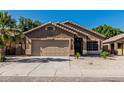 Inviting single-story home with a well-kept lawn and an attached two-car garage at 16242 W Maui Ln, Surprise, AZ 85379