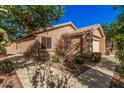 Single-story home showcasing desert landscaping, a concrete driveway, and a tile roof at 16365 N 138Th Ave, Surprise, AZ 85374