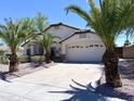 Attractive single-story home featuring a two-car garage and mature palm trees at 1679 E Oakland St, Gilbert, AZ 85295