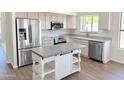 Bright kitchen featuring stainless steel appliances, an island, and granite countertops at 1679 E Oakland St, Gilbert, AZ 85295