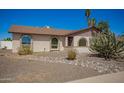 Front exterior of tan home with rock landscaping, rounded windows and brown trim at 17244 N 36Th Ln, Glendale, AZ 85308