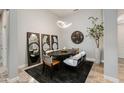 Well lit Dining room with an oval table, area rug, and decorative lighting and mirrors at 1753 N Berrett --, Mesa, AZ 85207