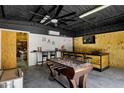 Finished garage features a game room with foosball table, bar and tv at 18132 E Vencino St, Gilbert, AZ 85298