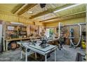 Workshop with work benches, various power tools and insulated ceiling at 18132 E Vencino St, Gilbert, AZ 85298
