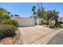 Inviting one-story home with a two-car garage, secure gated entry, and beautiful desert landscaping at 19 E Boca Raton Rd, Phoenix, AZ 85022