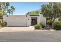 Charming single-story home featuring a two-car garage, secure gated front entry, and xeriscaped yard at 19 E Boca Raton Rd, Phoenix, AZ 85022