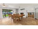 Spacious dining area with backyard access, large table, brick fireplace, and tile flooring at 1937 E Loyola Dr, Tempe, AZ 85282
