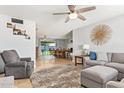 Inviting living room open to the dining area featuring tile floors, a ceiling fan, and cozy seating at 1937 E Loyola Dr, Tempe, AZ 85282