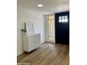 Stylish entryway with decorative cabinet, wood floors, and a decorative stained-glass window at 1941 E Ellis Dr, Tempe, AZ 85282