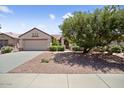 Lovely single-story home features a two-car garage, desert landscaping and a neutral color scheme at 20007 N Siesta Rock Dr, Surprise, AZ 85374
