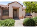 Inviting front entrance with desert landscaping, covered porch, and tiled roof at 20007 N Siesta Rock Dr, Surprise, AZ 85374