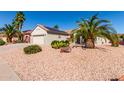 Beautiful desert home with desert landscaping, and a two-car garage, showcasing curb appeal at 20223 N Sundance Way, Surprise, AZ 85374