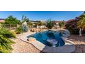 Resort-style pool with swim-up table, surrounded by desert landscaping and privacy fence at 20223 N Sundance Way, Surprise, AZ 85374
