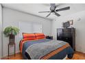Warm and inviting bedroom with wood flooring, ceiling fan, and ample natural light at 2121 N Center St # 198, Mesa, AZ 85201