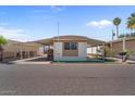 A mobile home with a covered porch, rock landscaping, and a carport at 2121 N Center St # 198, Mesa, AZ 85201