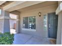 Inviting front porch with stylish lighting fixture and welcoming front door at 22121 N Greenland Park Dr, Maricopa, AZ 85139