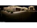 Stunning stone home with attached garage and driveway, illuminated by roofline Christmas lights at 24348 S 201St Ct, Queen Creek, AZ 85142