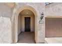 Close-up of home entrance with arched doorway, address numbers, and stucco facade at 27413 W Tonopah Dr, Buckeye, AZ 85396