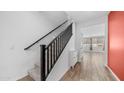 Carpeted staircase with black banister leading to the upper level of the home at 31653 N 24Th Dr, Phoenix, AZ 85085