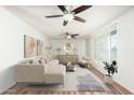 Stylishly staged living room with a plush sofa, elegant decor, and a large window at 3231 W Banff Ln, Phoenix, AZ 85053