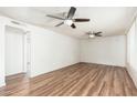 Spacious living room with two ceiling fans and wood-look flooring at 3231 W Banff Ln, Phoenix, AZ 85053