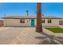 Charming single-story home with a well-maintained yard, stone landscaping, and a bright blue front door at 3302 N 40Th Dr, Phoenix, AZ 85019