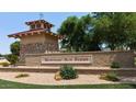 Welcome to Morning Sun Farms; a beautiful community with lush landscaping, decorative stone walls, and mature trees at 34970 N Spur Cir, San Tan Valley, AZ 85144
