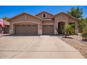 Charming single-story home featuring a three-car garage, desert landscaping, and neutral stucco facade at 3823 E Kroll Dr, Gilbert, AZ 85234