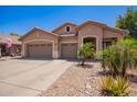 Charming single-story home featuring a three-car garage, desert landscaping, and neutral stucco facade at 3823 E Kroll Dr, Gilbert, AZ 85234