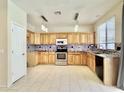 Modern kitchen with granite countertops, stainless steel appliances, and ample cabinet space at 4002 E Agave Rd, Phoenix, AZ 85044