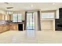 Open kitchen featuring tile flooring, granite counters, modern appliances, and backyard access at 4002 E Agave Rd, Phoenix, AZ 85044