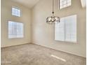 Bright living room boasting soaring ceilings, ample natural light, and contemporary chandelier at 4002 E Agave Rd, Phoenix, AZ 85044