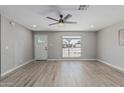 Bright living room featuring wood-look floors and neutral paint, large window at 4441 N 27Th Dr, Phoenix, AZ 85017
