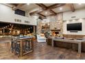 Bright living room features wooden floors, stone fireplace, exposed beam ceilings and an open floorplan at 4610 E Meadowview Dr, Gilbert, AZ 85298