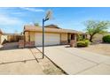 Welcoming single-Gathering home featuring an attached garage and a well-kept front yard at 6128 W Columbine Dr, Glendale, AZ 85304