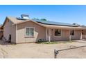 Single-story home featuring solar panels, fenced front yard, neutral paint, and covered entry at 6814 W Berkeley Rd, Phoenix, AZ 85035