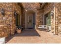 Inviting front entrance featuring beautiful stone work and a cozy sitting area at 7134 E Sandia St, Mesa, AZ 85207