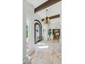 Inviting foyer with high ceilings, stone floors, and a decorative chandelier at 7214 E Royal Palm Rd, Scottsdale, AZ 85258