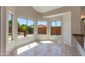 Bright breakfast nook features tile flooring, multiple windows, and backyard views at 7421 S 25Th Ln, Phoenix, AZ 85041