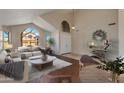 Bright living room featuring high ceilings, large arched windows, and modern decor at 7421 S 25Th Ln, Phoenix, AZ 85041