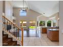 Open-concept living room with a fireplace and large windows provides natural light at 7421 S 25Th Ln, Phoenix, AZ 85041