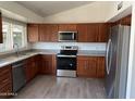 Updated kitchen featuring stainless steel appliances, modern cabinetry, and granite countertops at 8117 W Dreyfus Dr, Peoria, AZ 85381