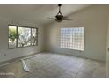 Bright living room featuring tile floors and two types of windows letting in ample natural light at 8117 W Dreyfus Dr, Peoria, AZ 85381