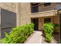 Well-maintained condo entrance with private patio and lush green landscaping at 8301 N 21St Dr # F102, Phoenix, AZ 85021